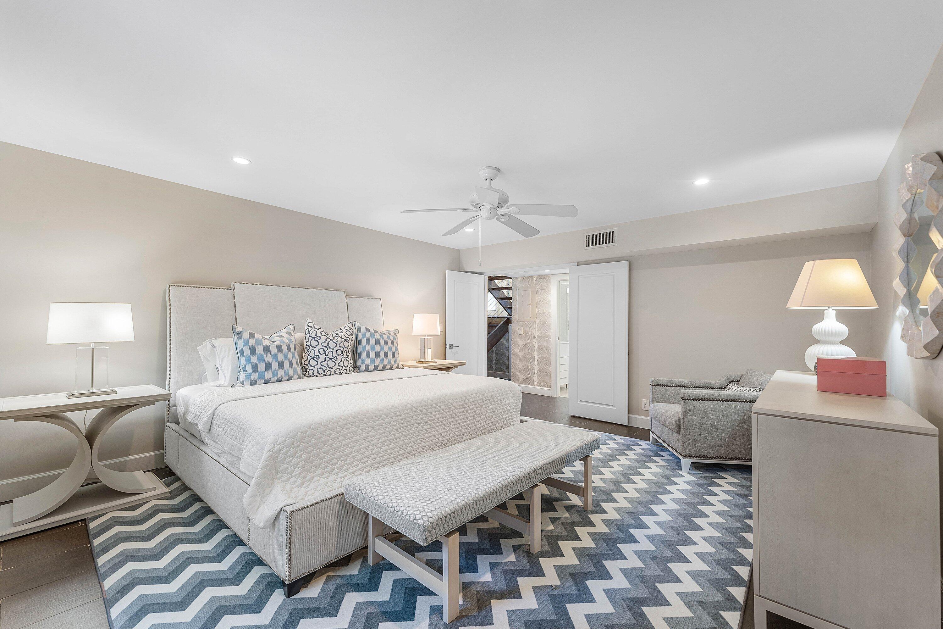 811 Palm Trail Delray Beach, FL 33483 - Photo 29 of 57 a spacious bedroom with a bed and a chandelier