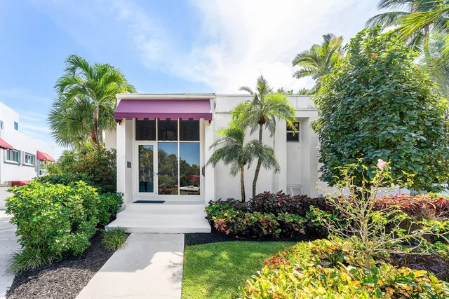a view of a lake with boats and trees in the background