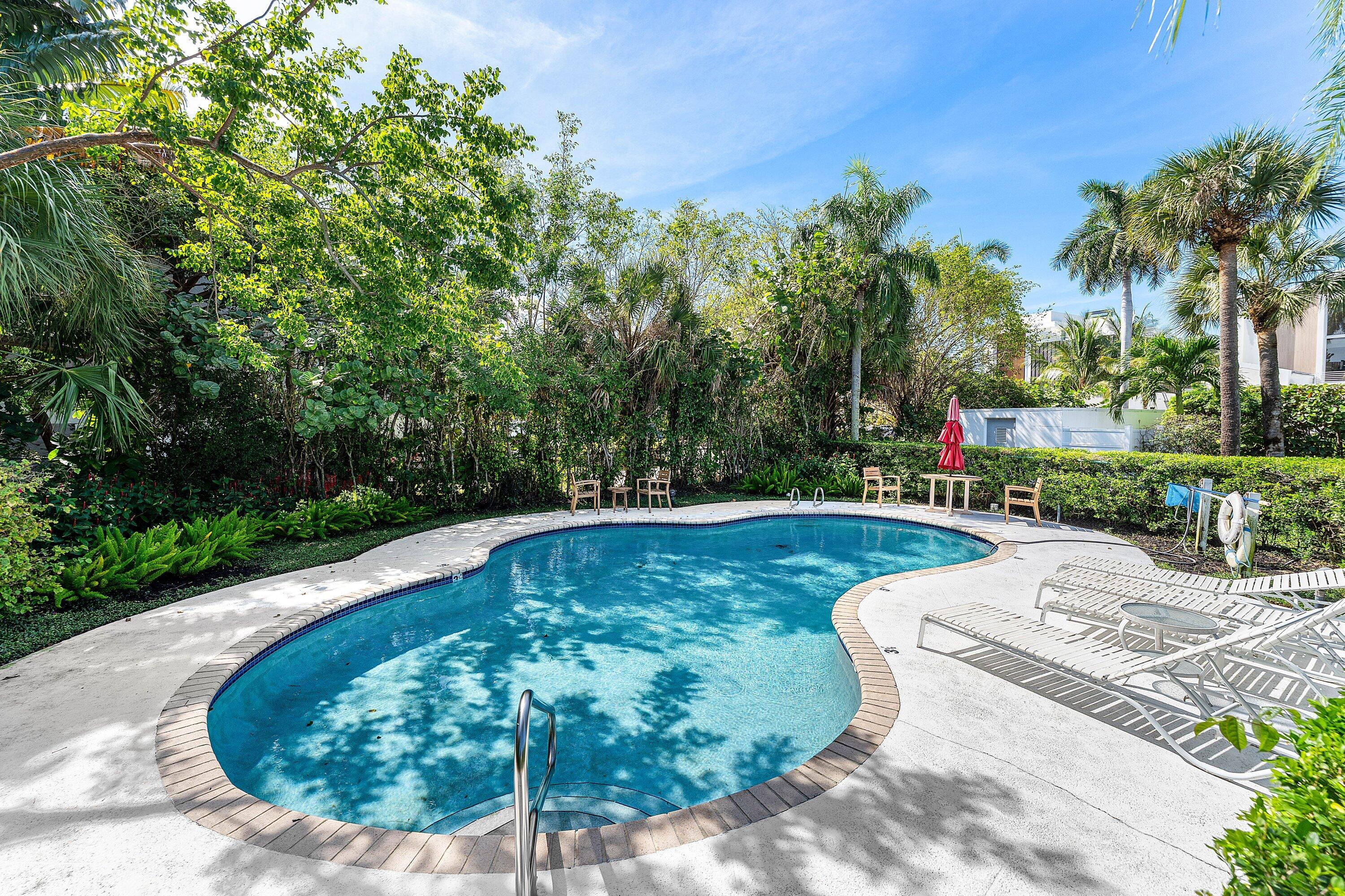 811 Palm Trail Delray Beach, FL 33483 - Photo 48 of 57 a view of a swimming pool with a patio
