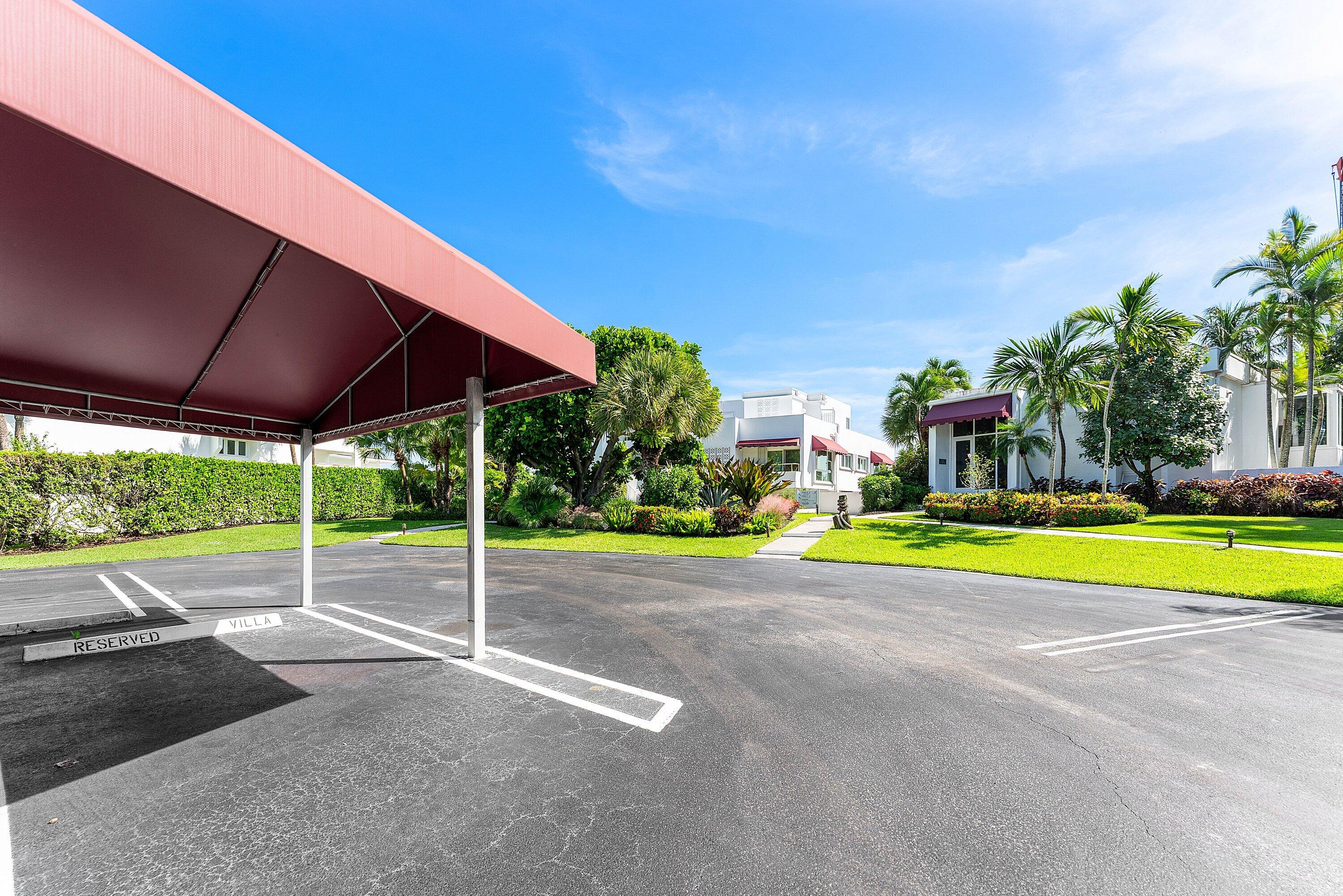 811 Palm Trail Delray Beach, FL 33483 - Photo 49 of 57 a view of pool with table and chairs under an umbrella