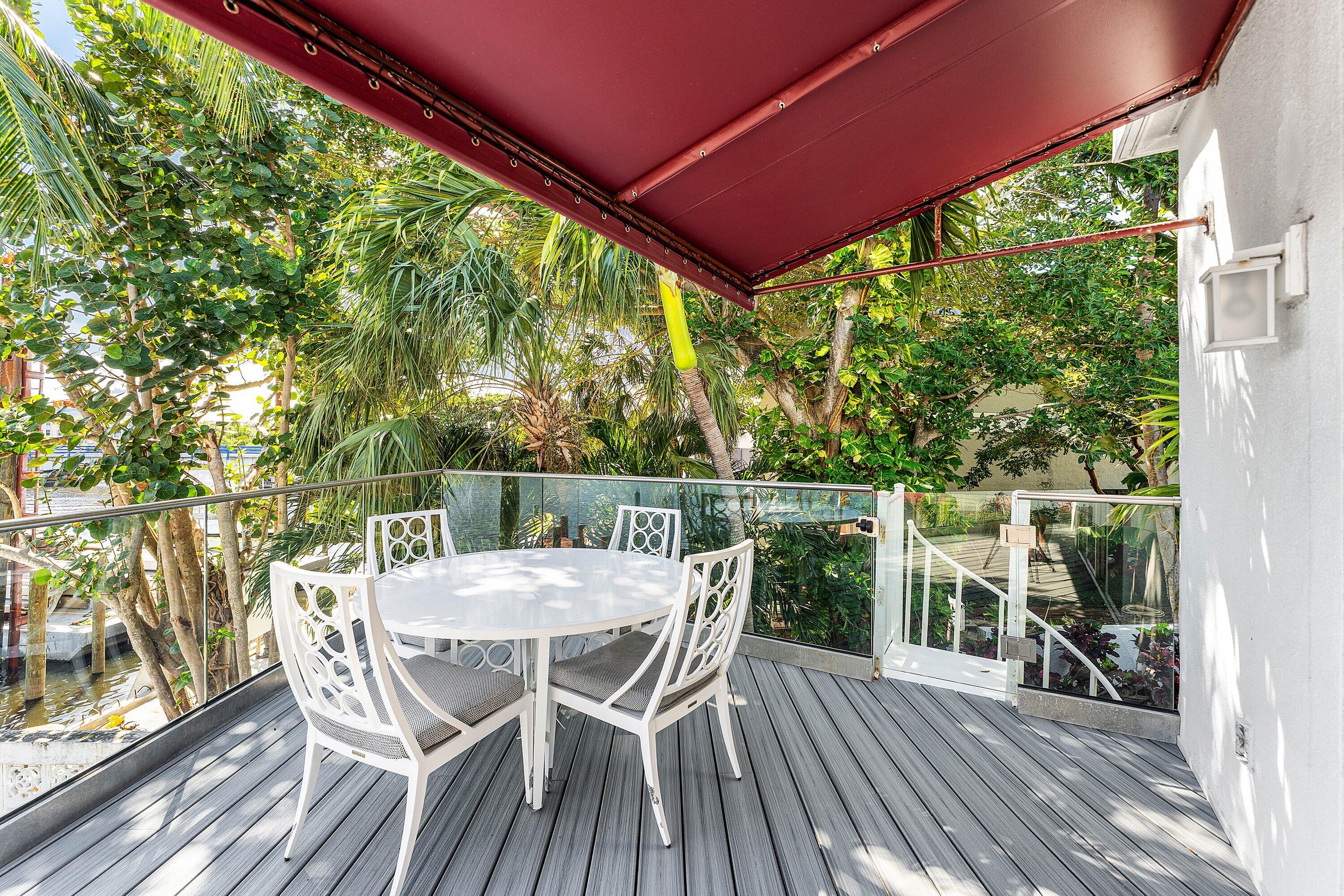 811 Palm Trail Delray Beach, FL 33483 - Photo 8 of 57 a view of a chairs and table in the balcony
