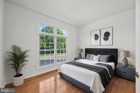 a bedroom with a large bed and a large window