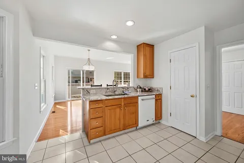 a spacious bathroom with a granite countertop sink and a mirror