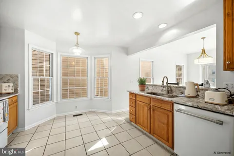 a spacious bathroom with a granite countertop sink and a mirror