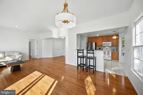 a living room with dining room and wooden floor