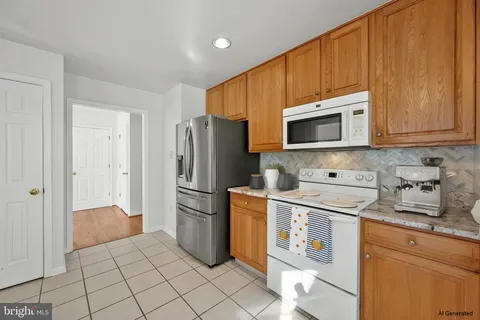 a kitchen with stainless steel appliances granite countertop a refrigerator stove and microwave