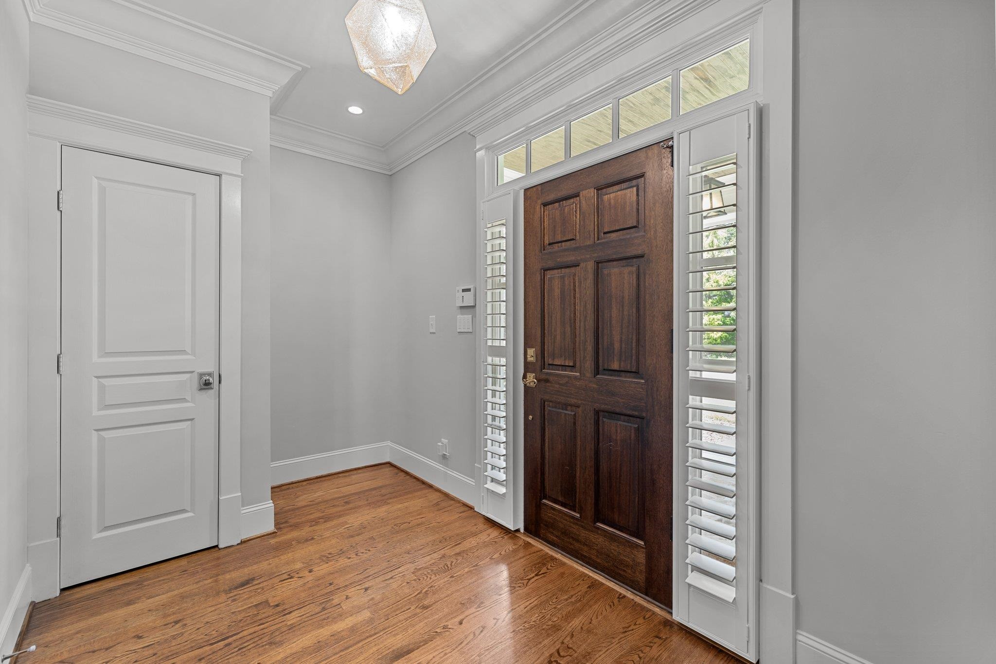 2116 Cowper Drive Raleigh, NC 27608 - Photo 3 of 65 The large foyer is an inviting welcome, beckoning you inside the home. Smart control lighting sets the mood for any occasion. Foyer