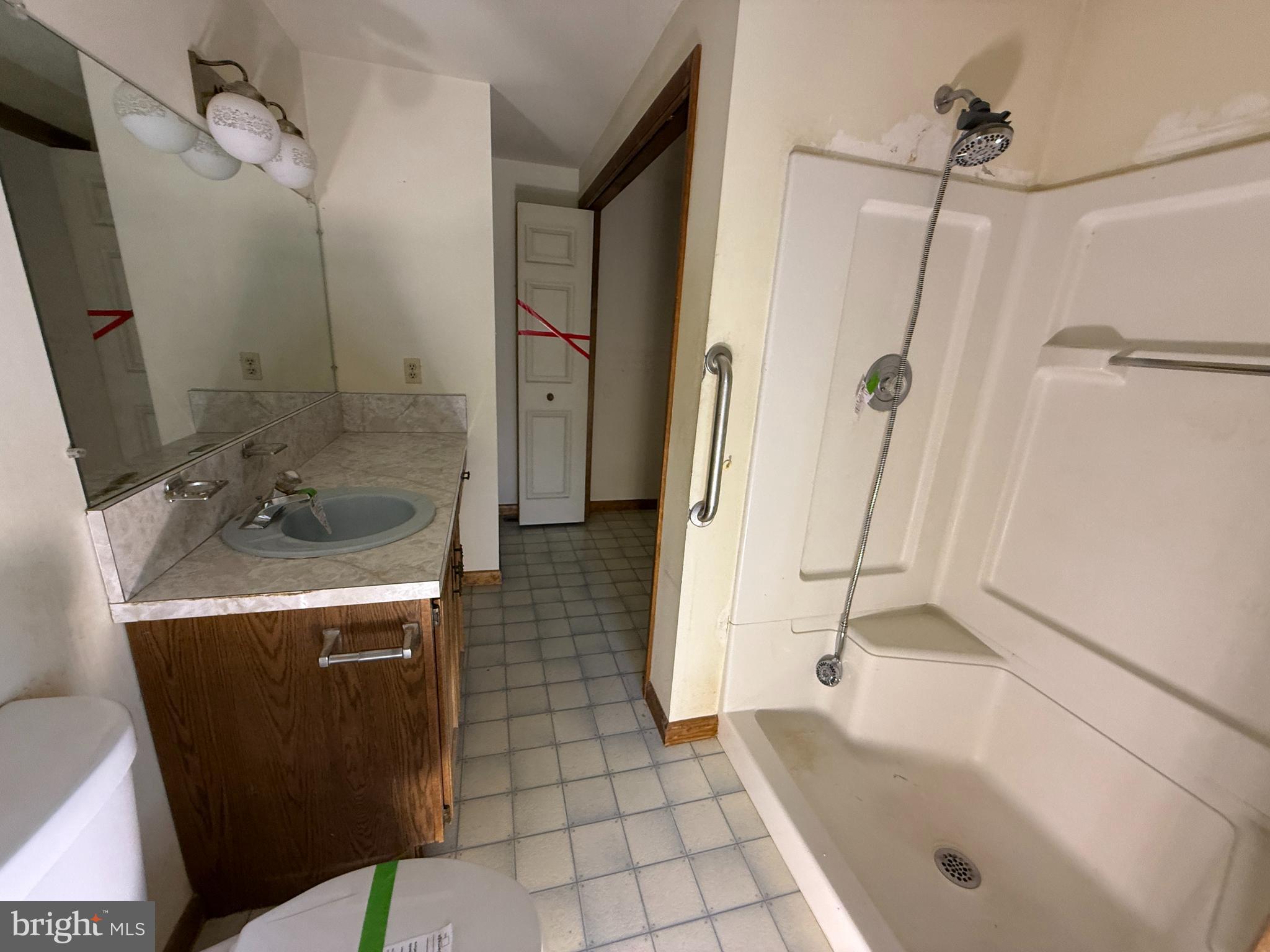 17827 Bakersville Road Boonsboro, MD 21713 - Photo 11 of 16 a bathroom with a granite countertop sink a toilet and shower