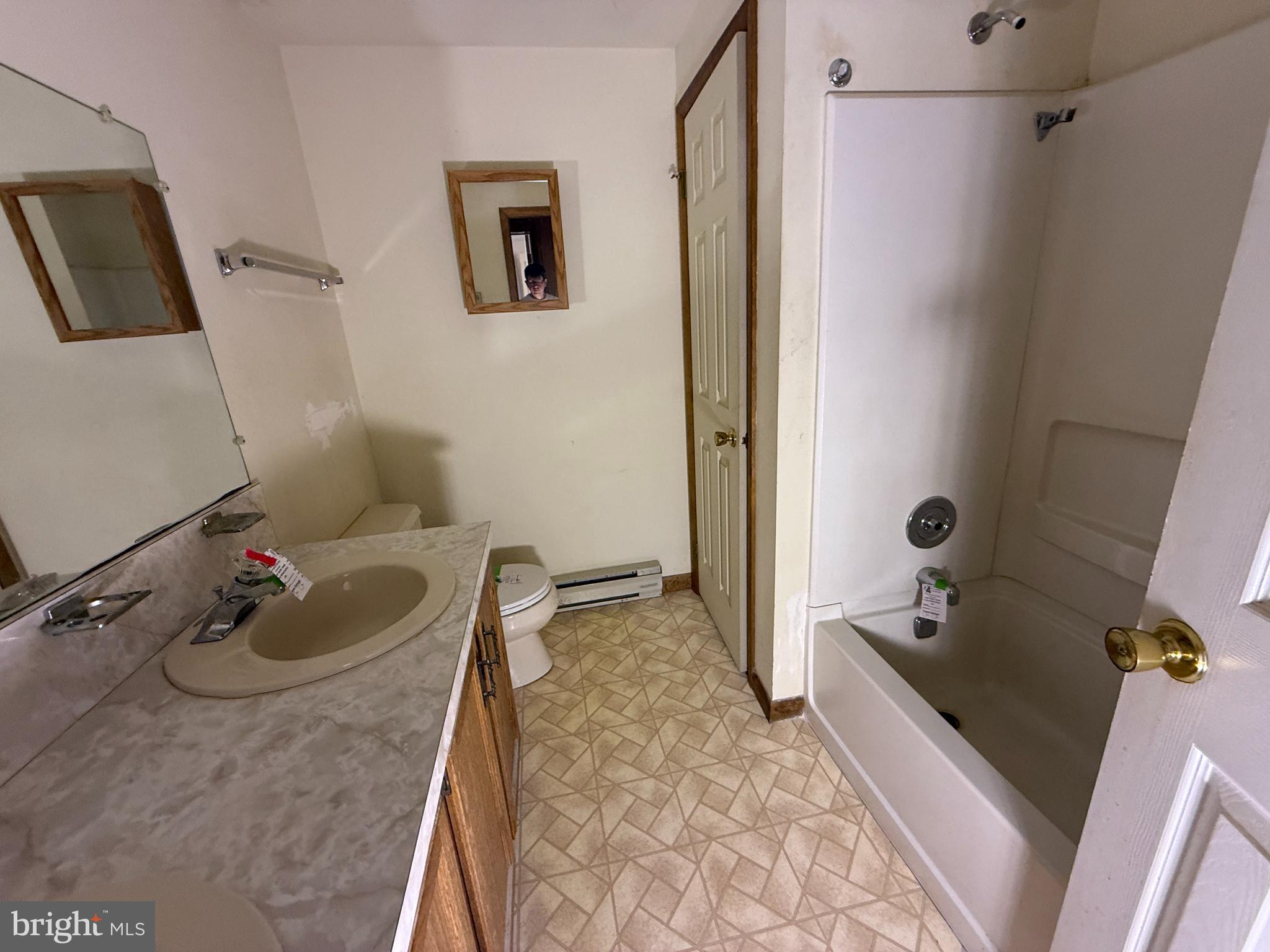 17827 Bakersville Road Boonsboro, MD 21713 - Photo 9 of 16 a bathroom with a tub sink and mirror