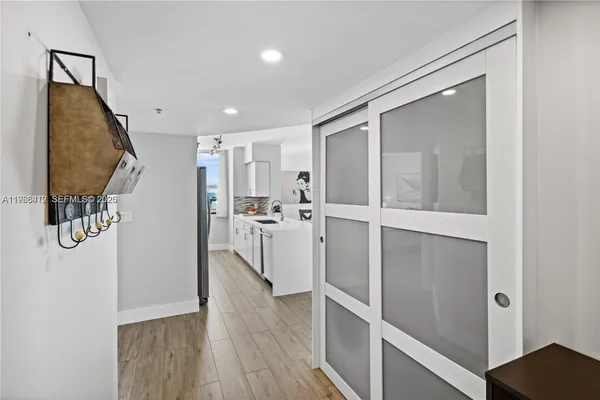 a view of a kitchen with wooden floor and staircase