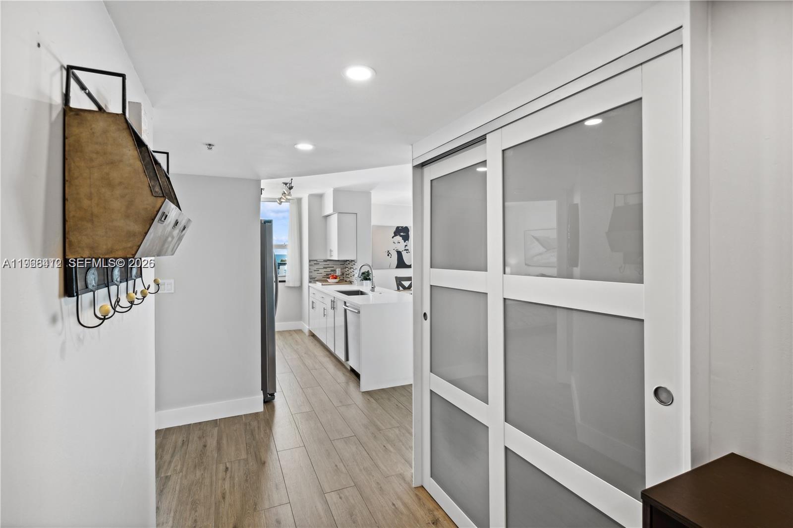 90 Alton Road, Unit 1901 Miami Beach, FL 33139 - Photo 14 of 17 a view of a kitchen with wooden floor and staircase