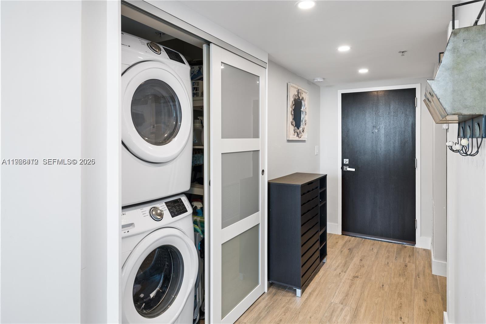 90 Alton Road, Unit 1901 Miami Beach, FL 33139 - Photo 15 of 17 a view of a hallway with washer and dryer