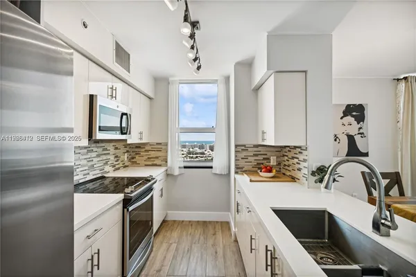 a kitchen with a sink stove and cabinets