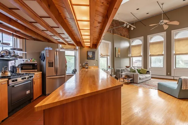 a kitchen with sink refrigerator and window