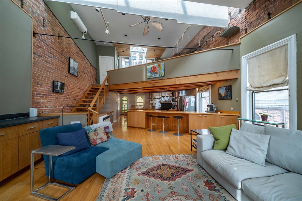 135 Main Street Northampton, MA 01060 - Photo 20 of 28 a living room with furniture and a floor to ceiling window