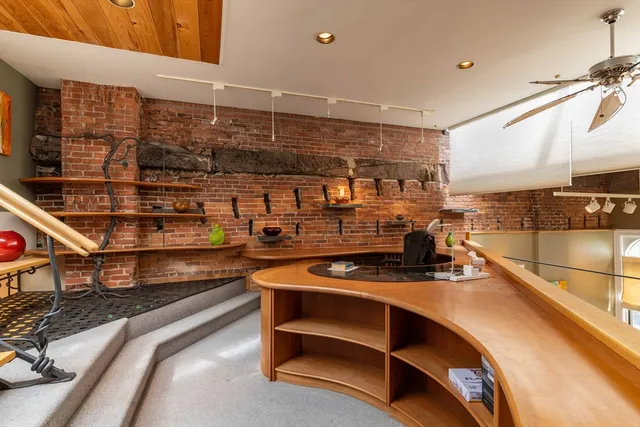 a kitchen with stainless steel appliances kitchen island granite countertop a stove and a sink