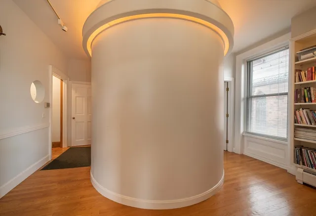 a view of a livingroom with wooden floor and windows