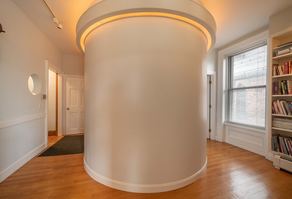 135 Main Street Northampton, MA 01060 - Photo 4 of 28 a view of a livingroom with wooden floor and windows