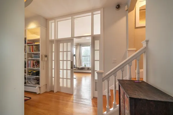 a view of entryway and hall with wooden floor