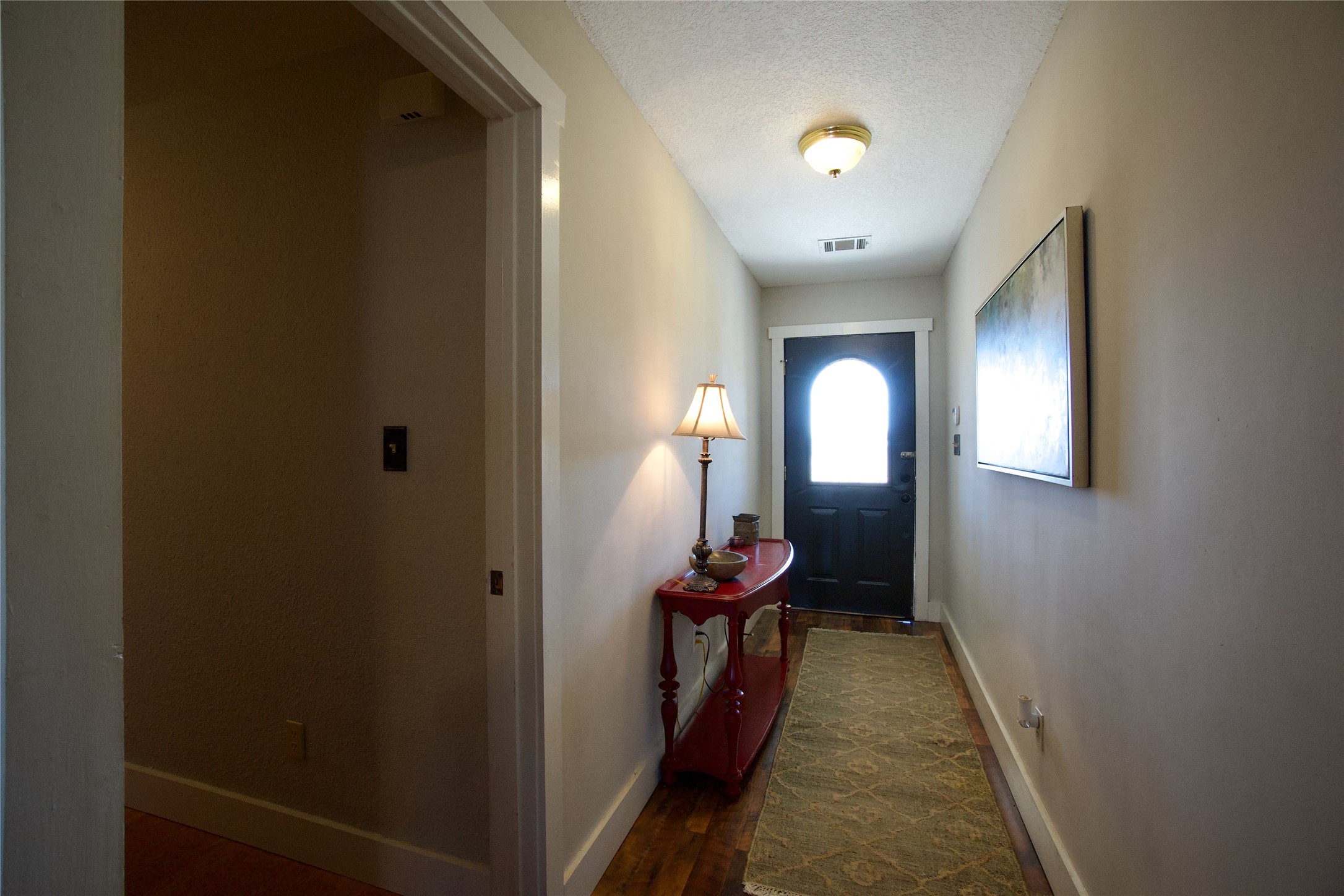 2352 Borchert Loop Lockhart, TX 78644 - Photo 15 of 39 a view of a hallway with wooden floor windows and a livingroom