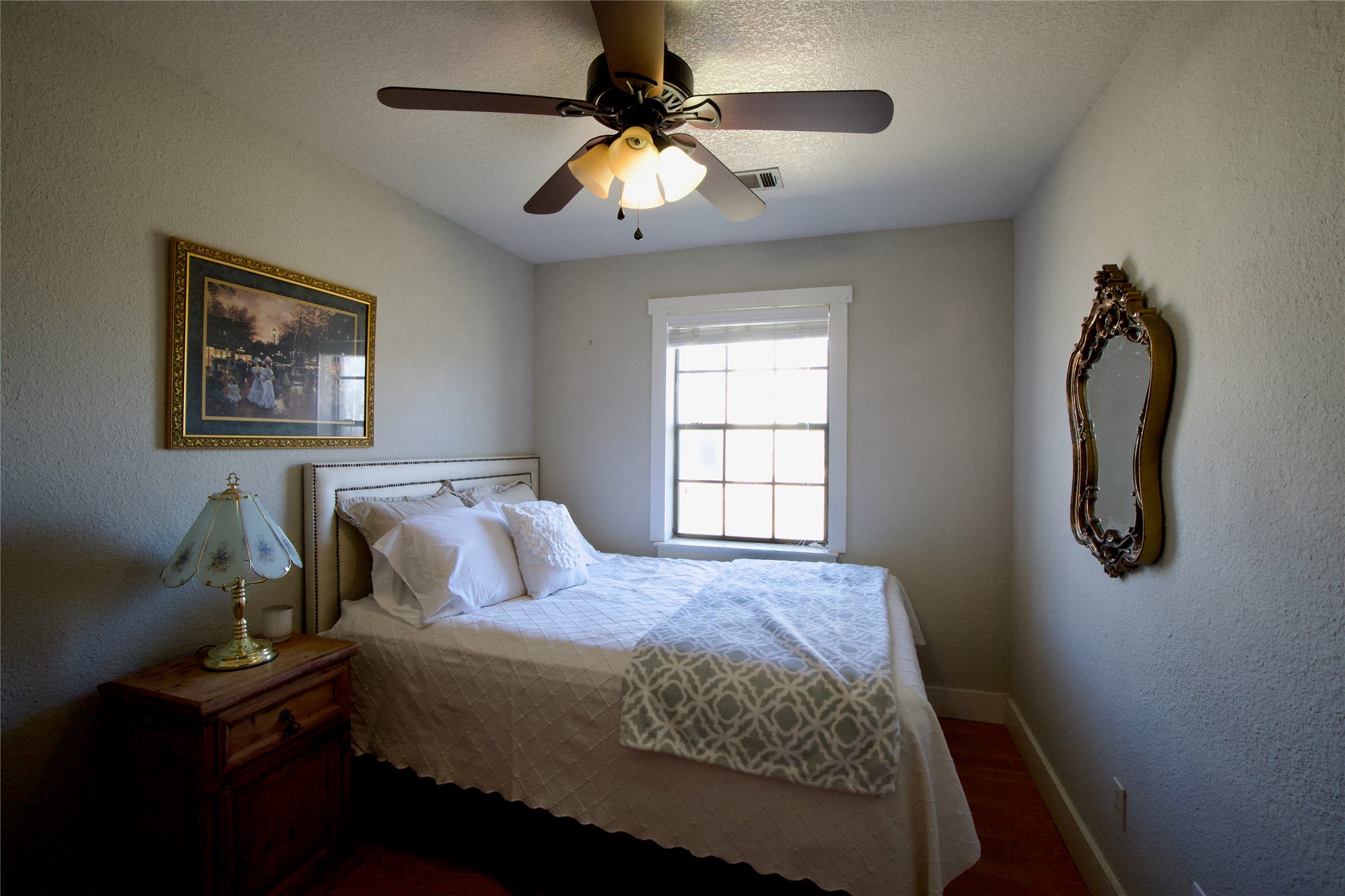 2352 Borchert Loop Lockhart, TX 78644 - Photo 22 of 39 a bedroom with a bed and a chandelier