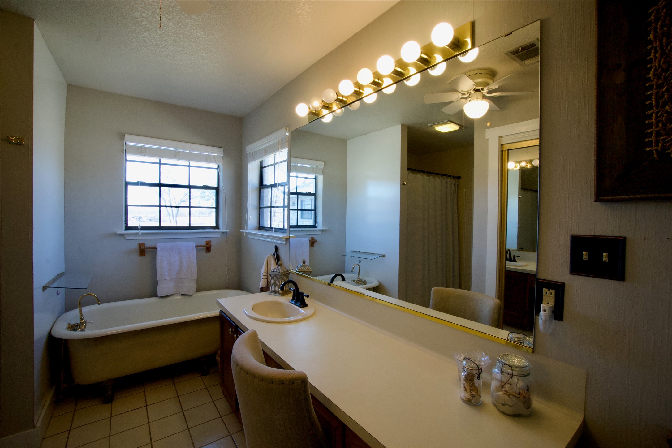 2352 Borchert Loop Lockhart, TX 78644 - Photo 25 of 39 a bathroom with a sink a large mirror and a bathtub