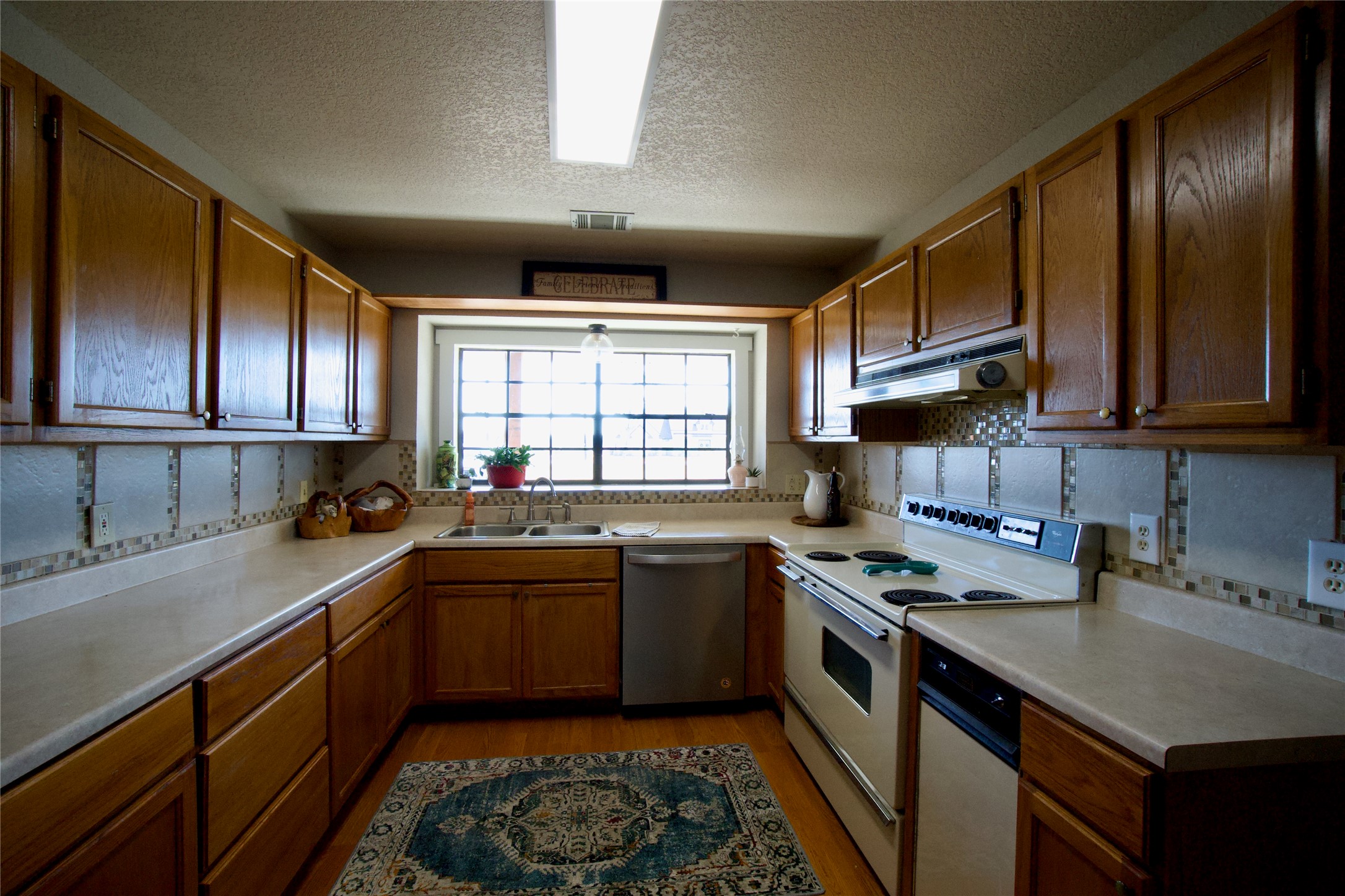 2352 Borchert Loop Lockhart, TX 78644 - Photo 9 of 39 a kitchen with a sink stove top oven and cabinets