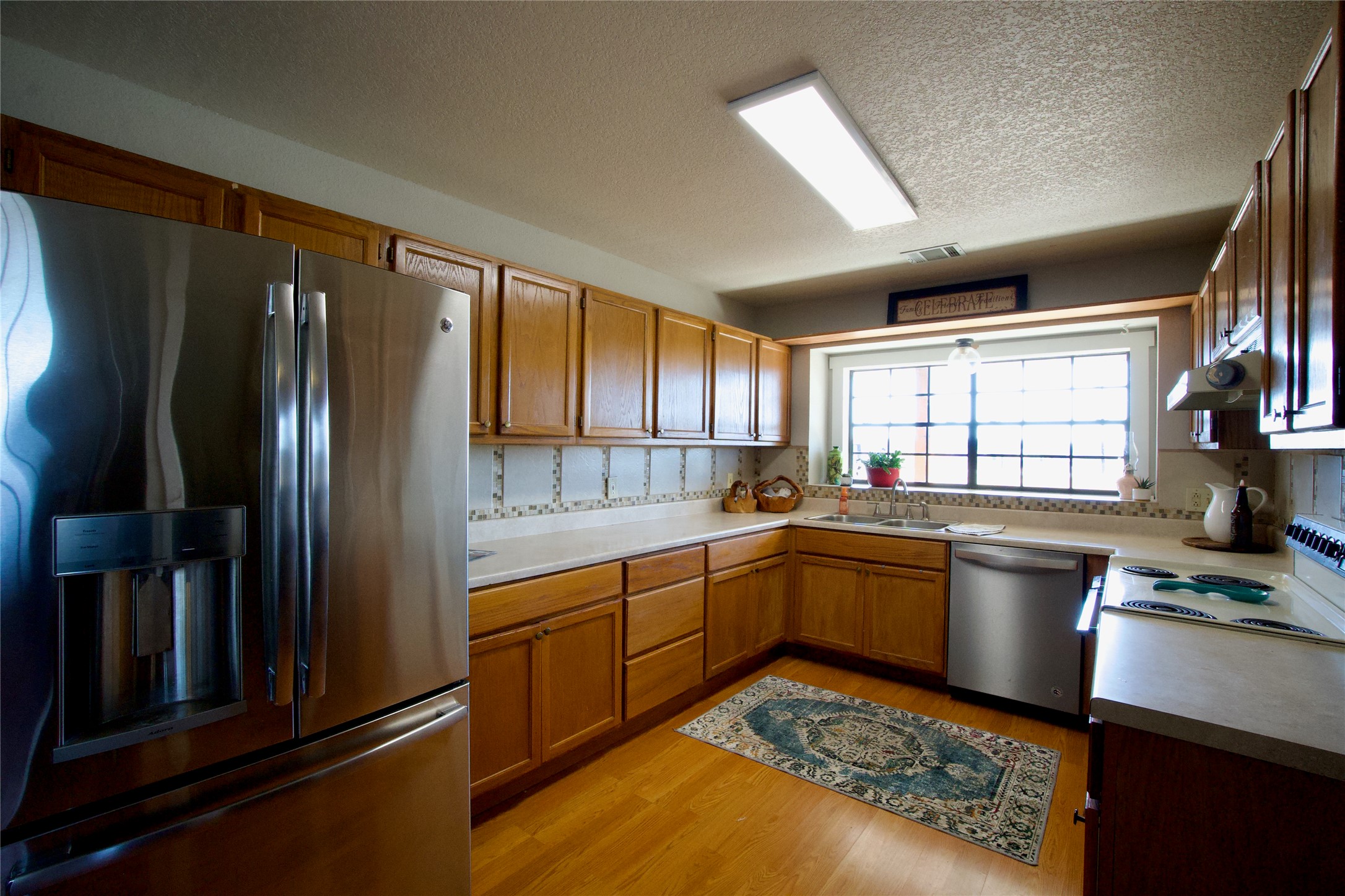 2352 Borchert Loop Lockhart, TX 78644 - Photo 10 of 39 a kitchen with a refrigerator and a sink