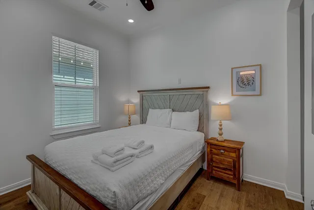 a bedroom with a bed and a night stand