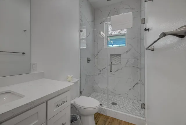 a bathroom with a sink toilet and shower