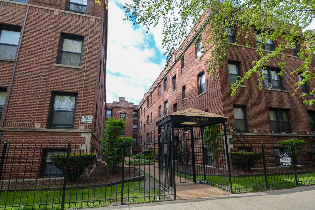 a view of a brick building with many windows