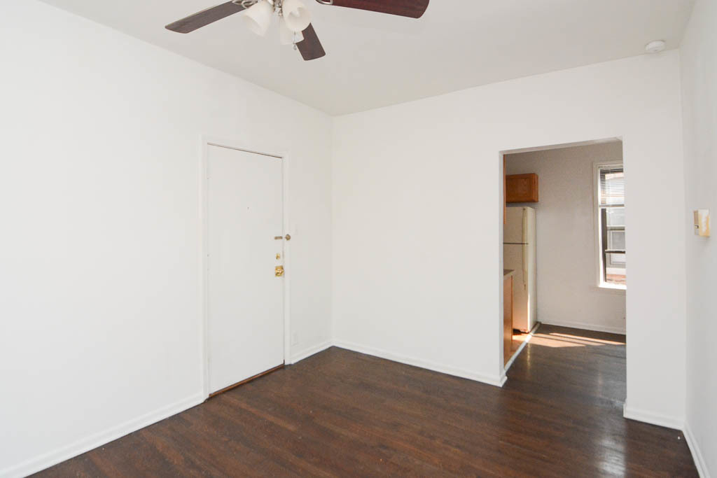 929 West Sunnyside Avenue, Unit 3S Chicago, IL 60640 - Photo 13 of 21 an empty room with wooden floor and a ceiling fan