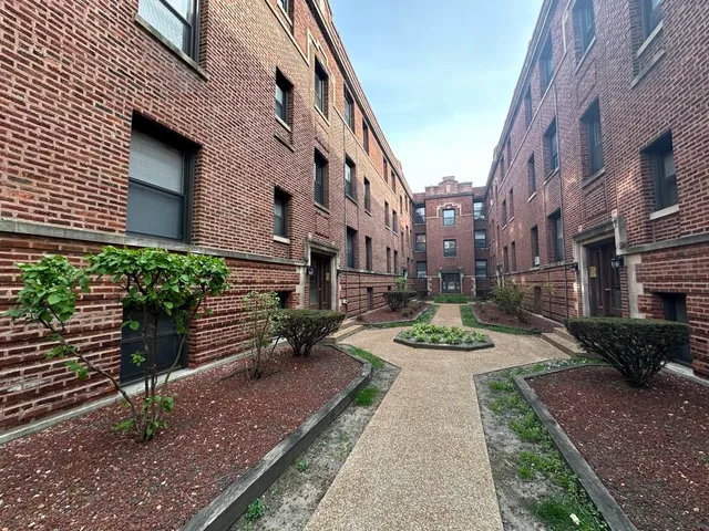 a view of a building with garden and sitting area