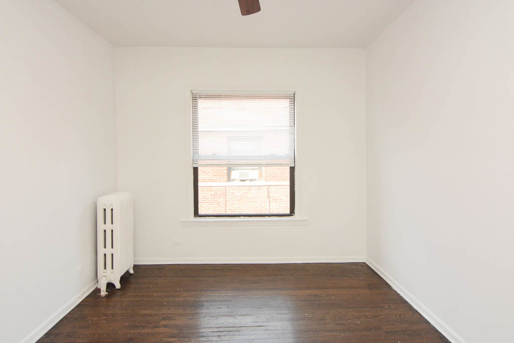 929 West Sunnyside Avenue, Unit 3S Chicago, IL 60640 - Photo 9 of 21 an empty room with wooden floor and windows