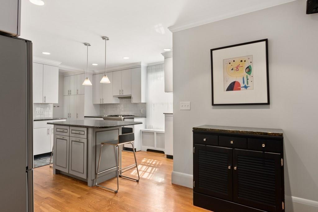 30 Homestead Road Marblehead, MA 01945 - Photo 21 of 35 a kitchen with stainless steel appliances granite countertop a stove a sink and a refrigerator with wooden floor