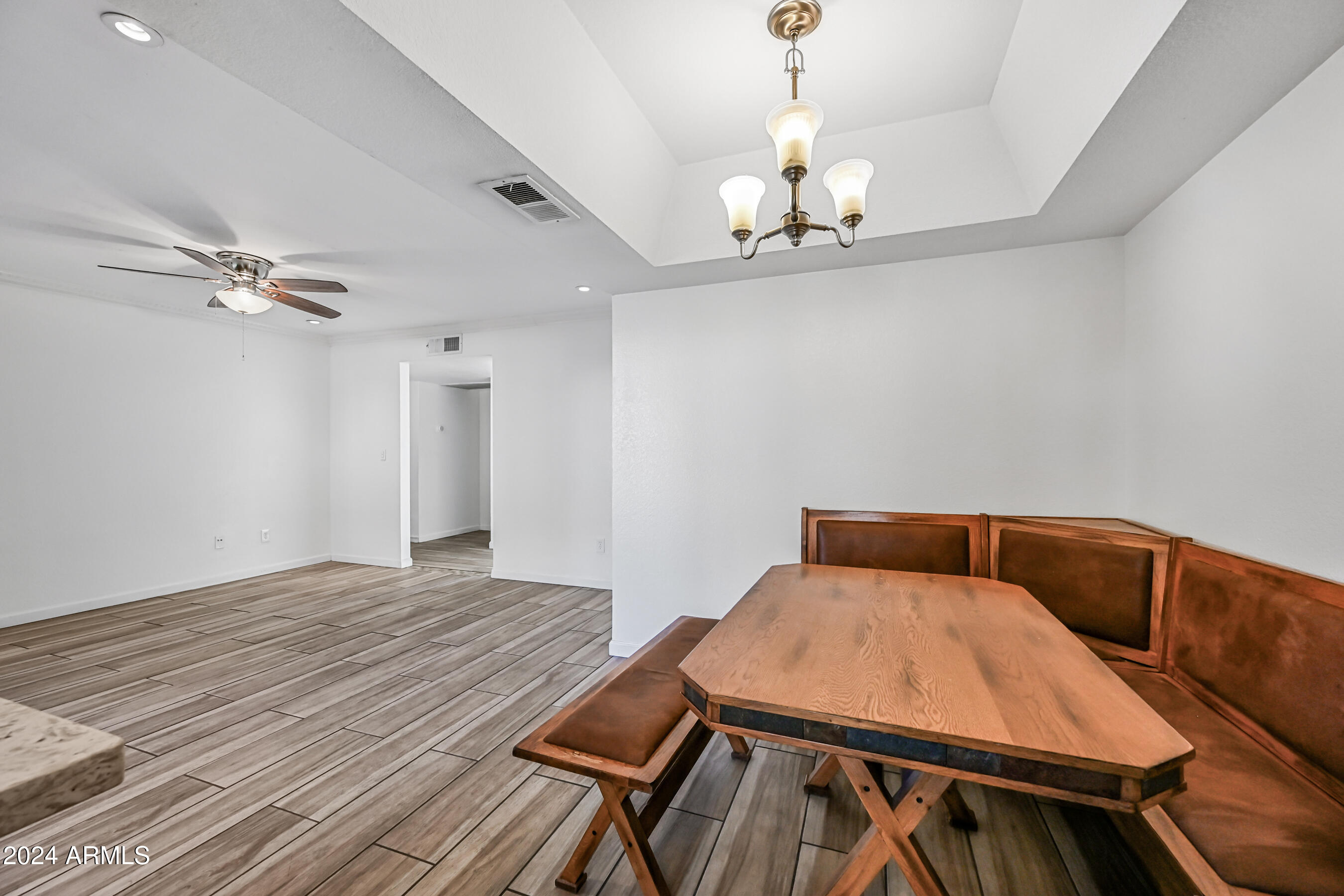 10610 South 48th Street, Unit 1081 Phoenix, AZ 85044 - Photo 11 of 17 a bedroom with a bed and a chandelier