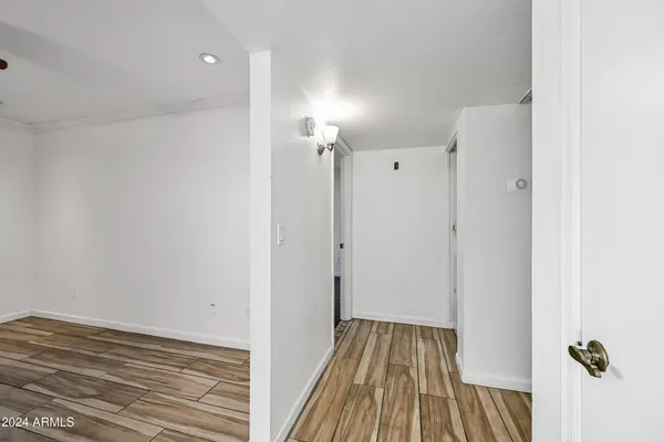 a view of a room with wooden floor