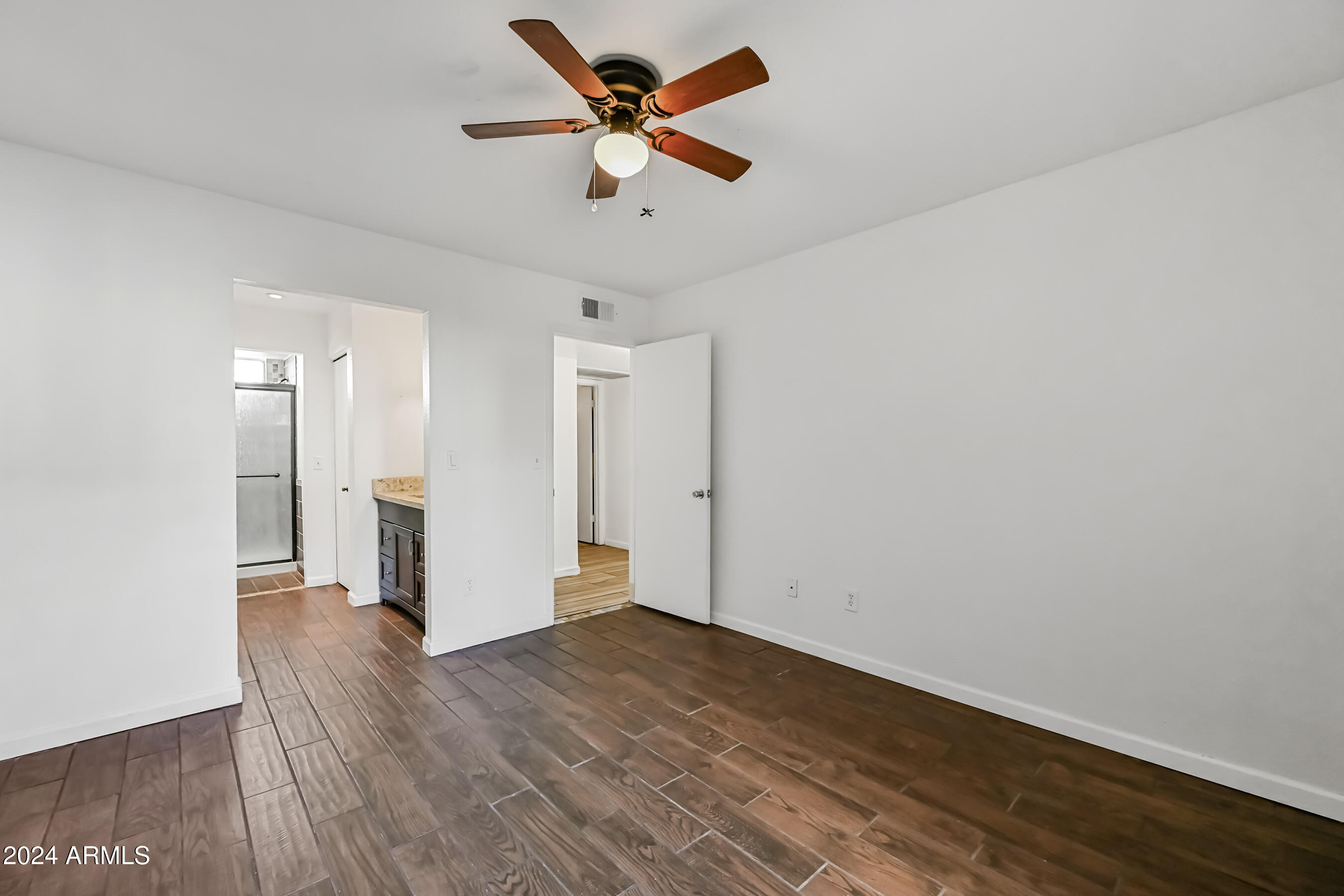 10610 South 48th Street, Unit 1081 Phoenix, AZ 85044 - Photo 15 of 17 a view of an empty room and wooden floor