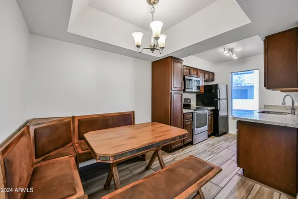 a living room with stainless steel appliances kitchen island granite countertop furniture and a kitchen view