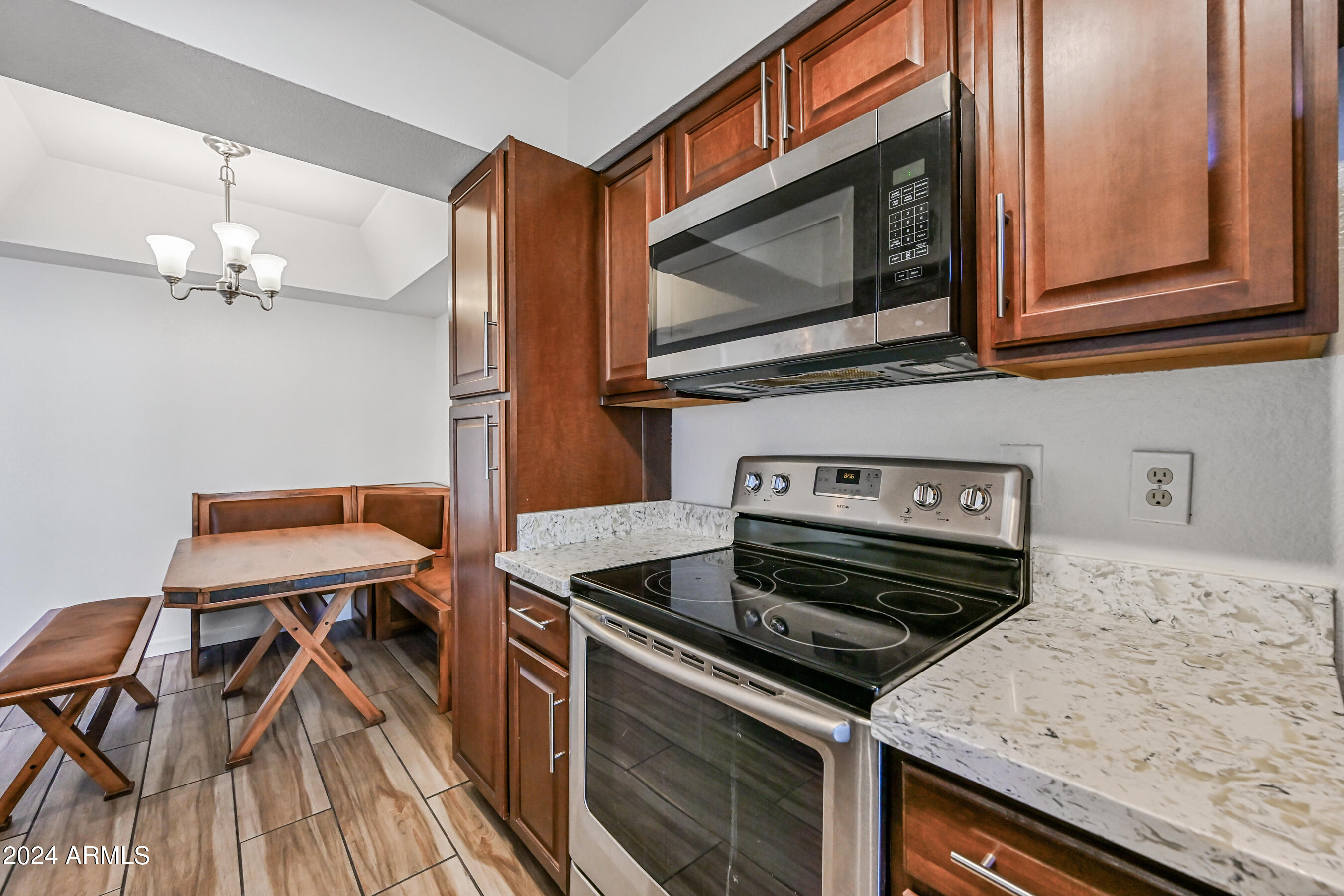 10610 South 48th Street, Unit 1081 Phoenix, AZ 85044 - Photo 10 of 17 a kitchen with a stove and a microwave