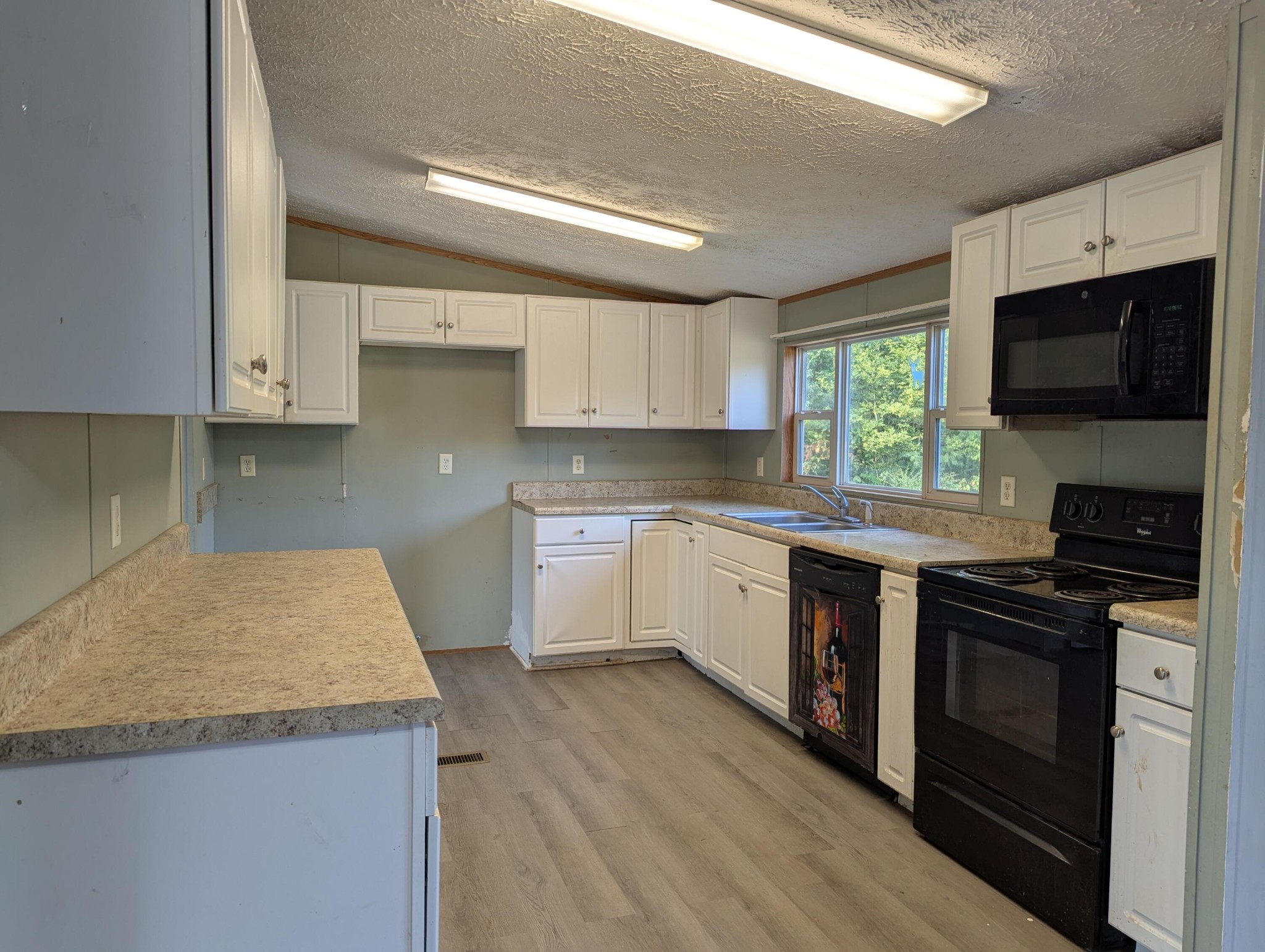 313 Burton Road Sweetwater, TN 37874 - Photo 8 of 38 a kitchen with granite countertop wooden cabinets and a stove