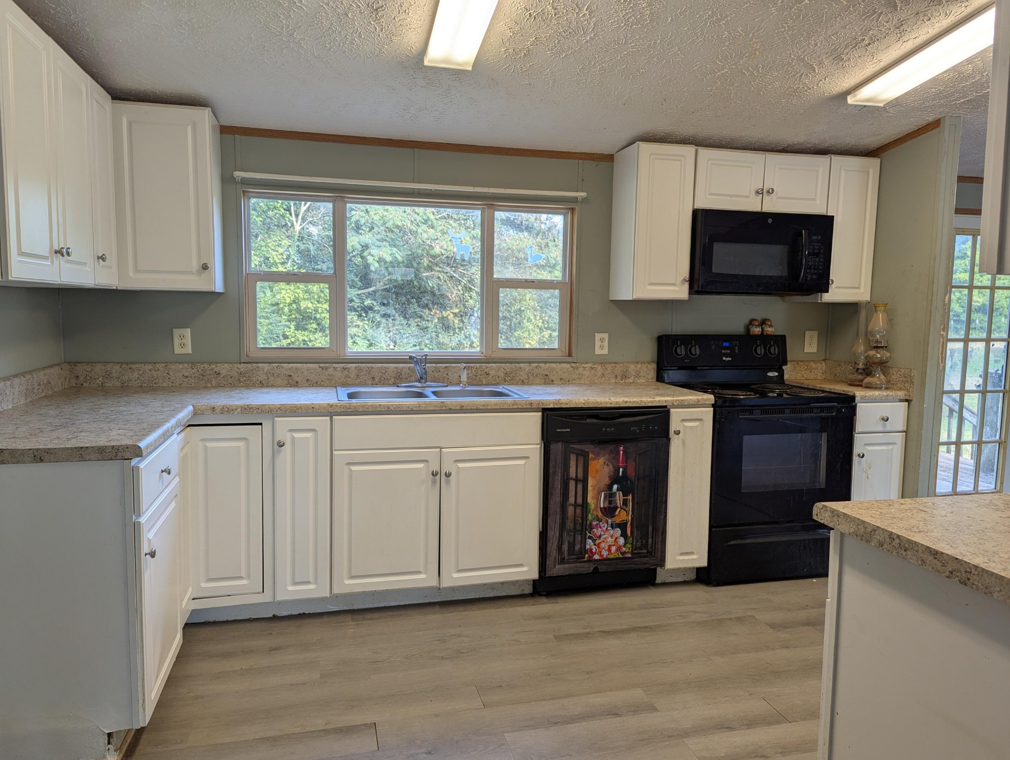 313 Burton Road Sweetwater, TN 37874 - Photo 9 of 38 a kitchen with stainless steel appliances granite countertop a sink and a stove top oven