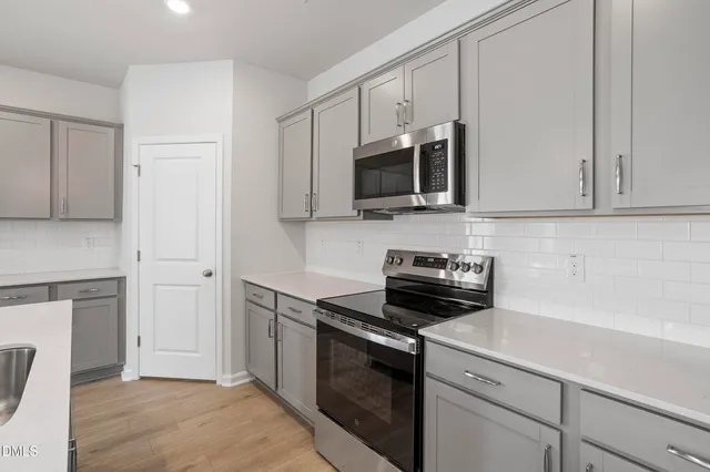 a kitchen with a sink stove and microwave
