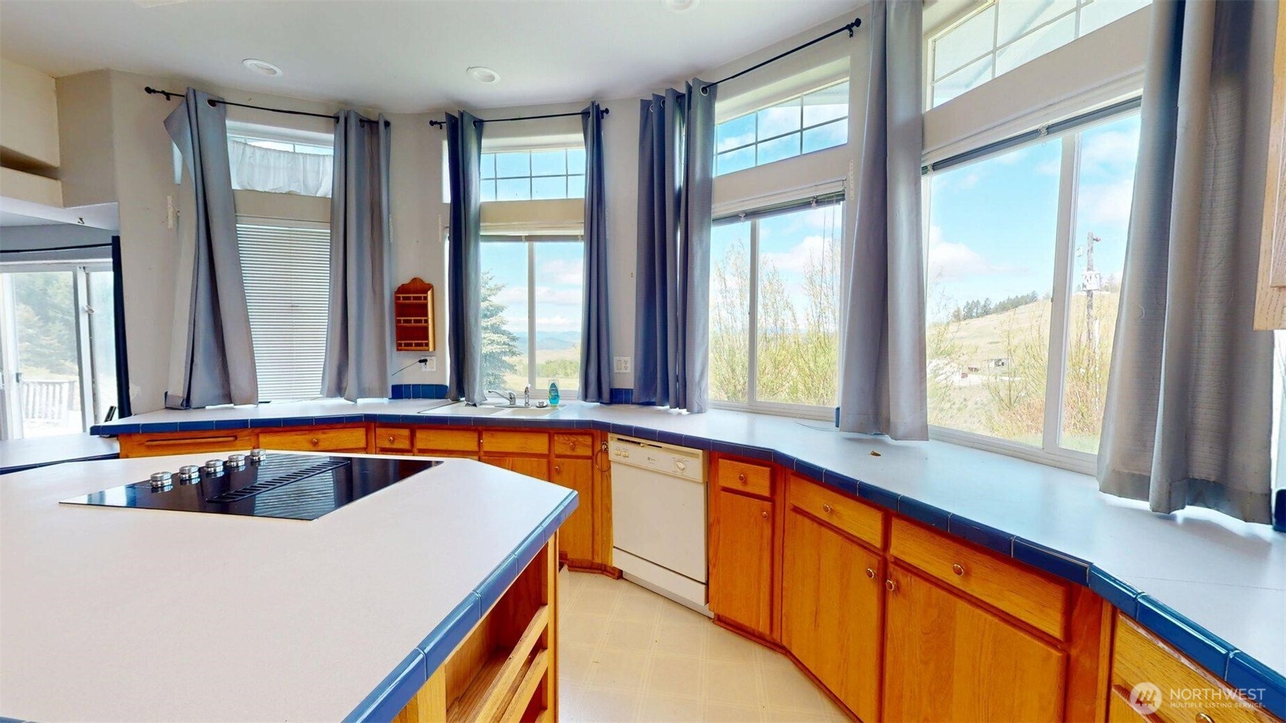 142 Fletcher Road Oroville, WA 98844 - Photo 8 of 26 a blue swimming pool with a glass top table and chairs