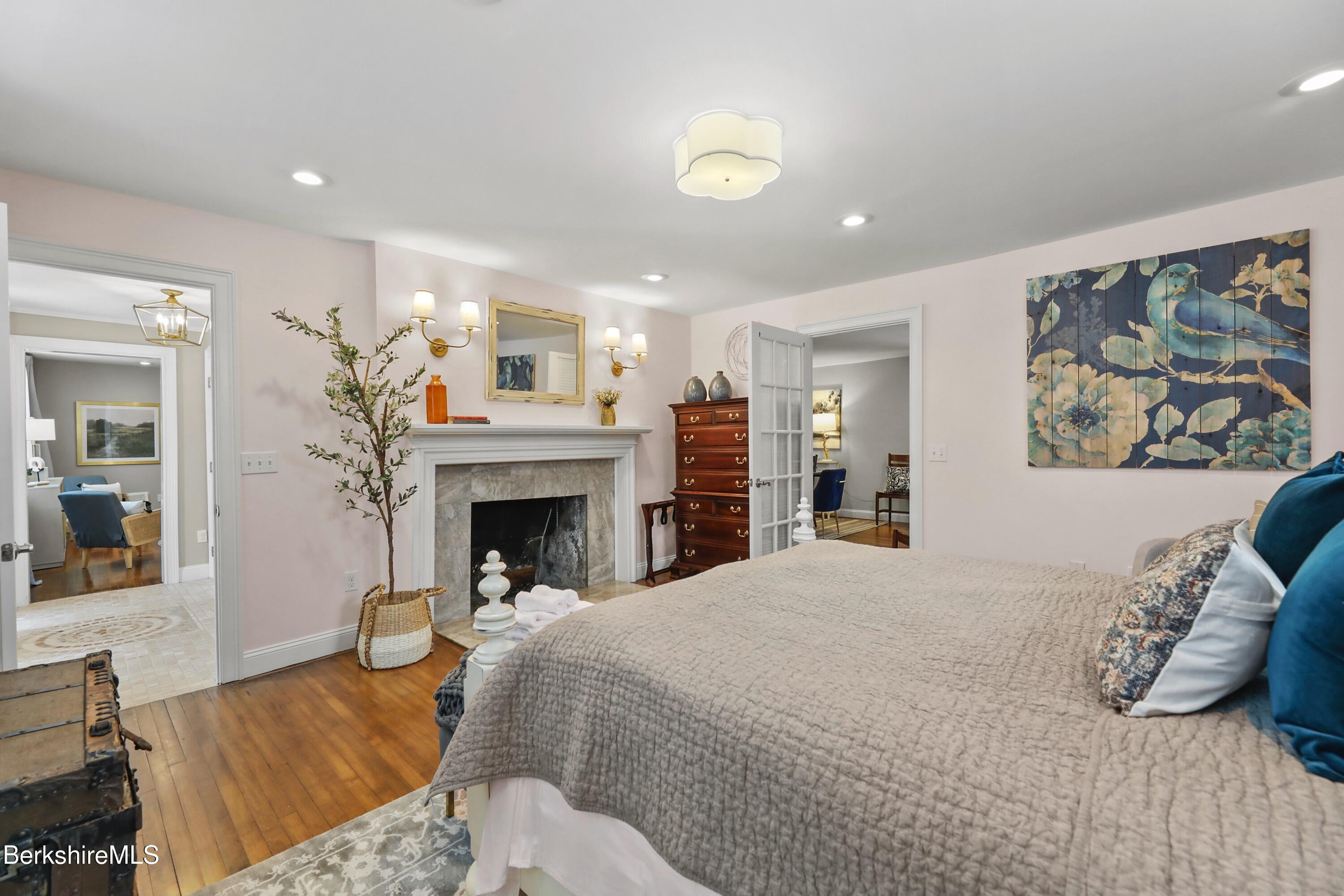 1 Devon Road Stockbridge, MA 01262 - Photo 39 of 58 a bedroom with a large bed and a fireplace