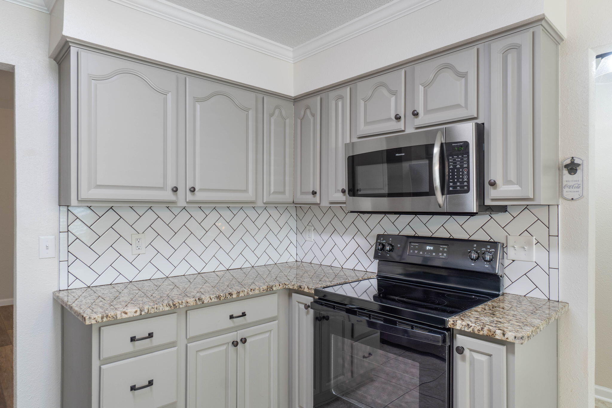 634 Lloyd Street Fort Walton Beach, FL 32547 - Photo 11 of 27 a kitchen with granite countertop white cabinets and stainless steel appliances