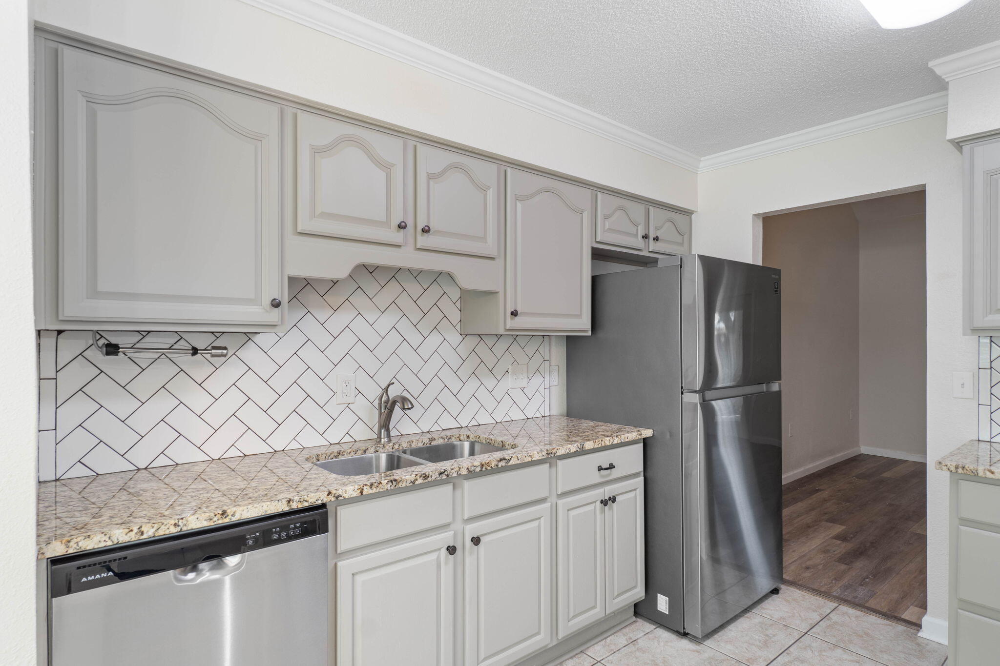 634 Lloyd Street Fort Walton Beach, FL 32547 - Photo 12 of 27 a kitchen with stainless steel appliances granite countertop a sink a refrigerator and a granite counter tops