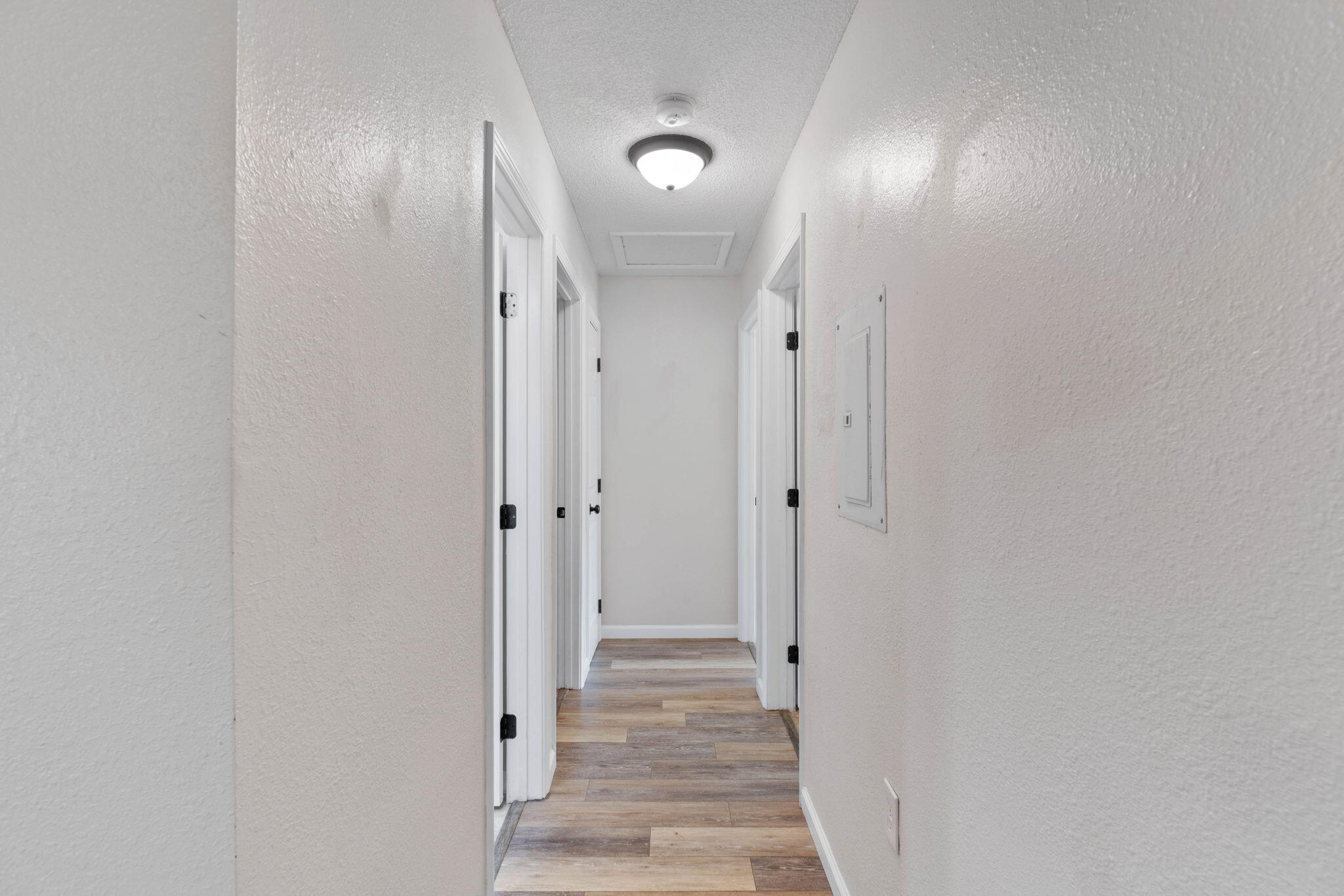634 Lloyd Street Fort Walton Beach, FL 32547 - Photo 14 of 27 a view of a hallway with wooden floor and cabinet
