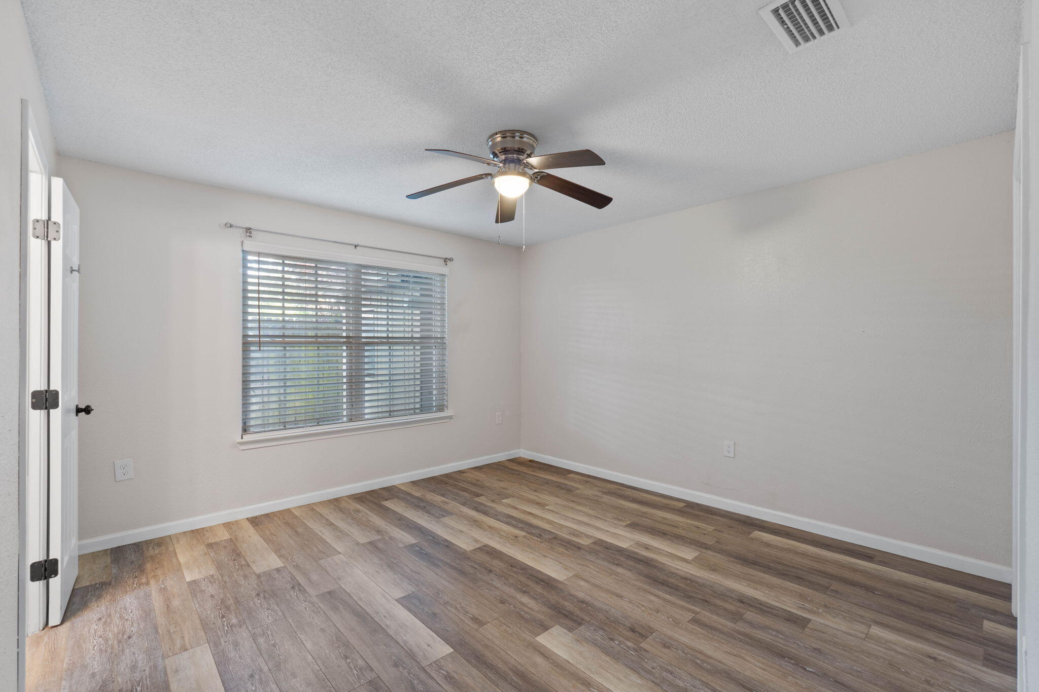 634 Lloyd Street Fort Walton Beach, FL 32547 - Photo 19 of 27 a view of empty room with wooden floor and fan