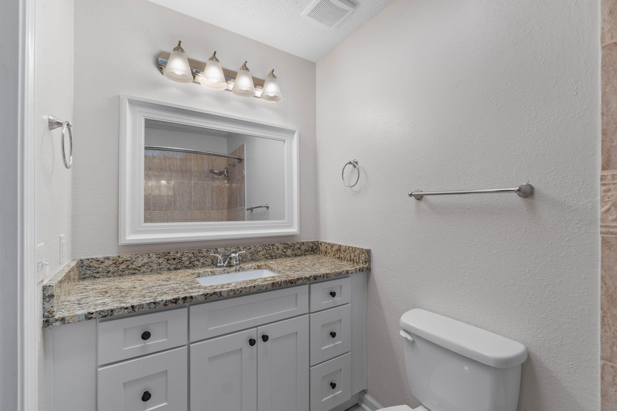634 Lloyd Street Fort Walton Beach, FL 32547 - Photo 23 of 27 a bathroom with a granite countertop sink vanity mirror and toilet
